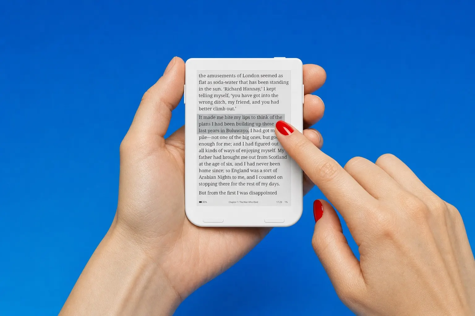 A fingertip tapping the touch screen of a white Snug Mini